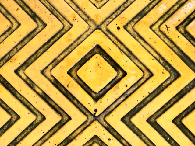 Textured surface of a plastic speed bump in a parking lot. (2018)