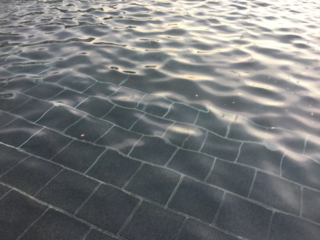 Golden hour sunlight caught by the shallow pool of a fountain in Washington, DC. (2017)